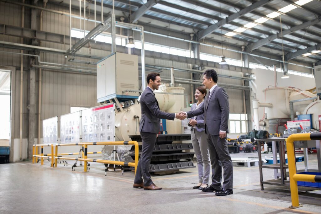 Business people shaking hands in the factory